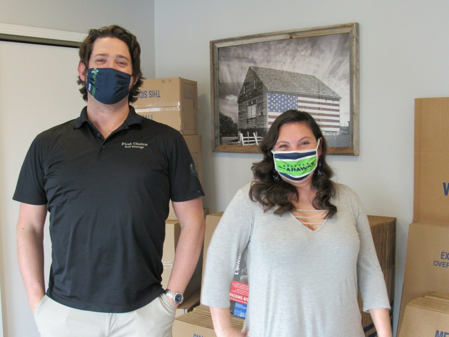 Two people Wearing a facemask inside of the storage - First Choice Self Storage
